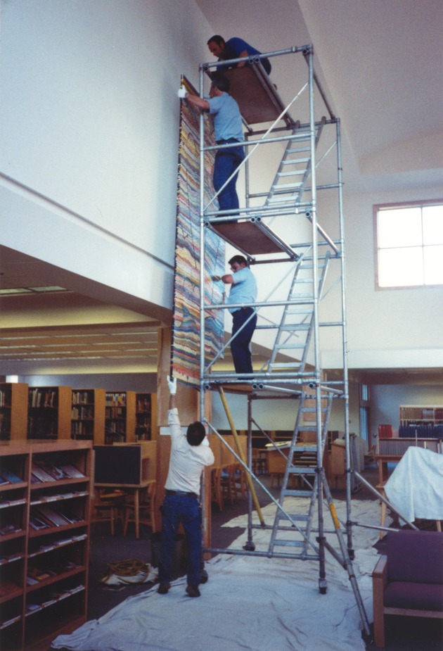 [Raising one panel of Mason mural, south wall, Kirk Library]