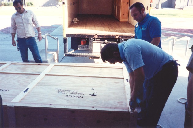 [Mural in crate being unloaded in front of the Library]